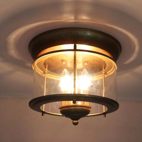 Rustic Gold 3-Light Flush Mount Ceiling Light With Clear Glass Shade, Antiqued Brass Finish, Vintage Style Fixture Illuminated