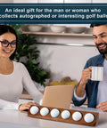 Walnut Wood Golf Ball Display Case 6 Standard Size Wall Mount Holder in office setting with a man and a woman