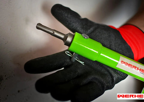 Green Earth Drill Adapter For Auger And Soil Drills With SDS Plus Chuck held by gloved hand