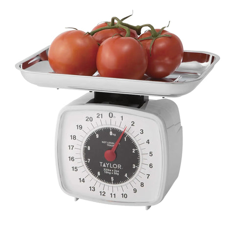 Old School Analog Kitchen Scale With Tare Function holding tomatoes, featuring 22 lb capacity multicolor dial and bold display.