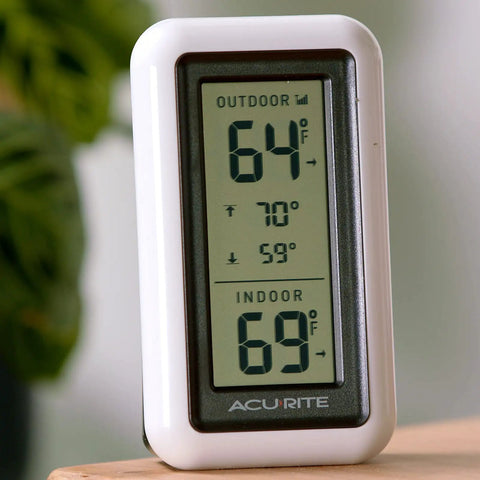 Digital Indoor Outdoor Thermometer With Wireless Sensor LCD Display And Daily High And Low Temperature Readings No Fuss Setup And Monitoring For Home Or Office White standing on a table.