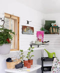 Garage with organized white SlatWall featuring tools, plants, and storage, showcasing Hands On Sample Ring With Wall And Ceiling Board Trim.