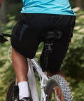 Cyclist on trail with suspension seatpost for mountain gravel and hybrid bikes with shock absorber aluminum alloy four link design.