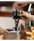 Three Piece Sleek Espresso Powder Receiver Cup And Dosing Funnel Fits 51 54 58Mm Portafilters in use for precise coffee distribution.