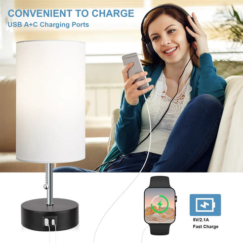 Woman with headphones using Three Color Temperature Bedside Lamp With USB A Port And USB C Port; lamp in modern room setting.