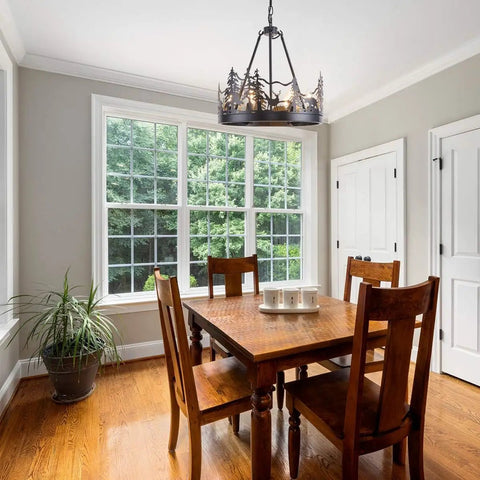 8-Light Wagon Wheel Chandelier In Black, Industrial Farmhouse Round Pendant Light over dining table in bright room