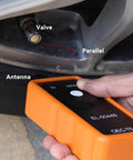Heavy Duty Tpms Relearn Tool Oec-T5 For No Mess Automotive Tire Pressure Sensor Activation Reset And Dead Easy Programming Setup Fits Virtually Any Ride Orange in use, showing valve and antenna.