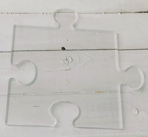 Clear acrylic puzzle piece template from Four In One Acrylic Router Template Kit for woodworking and charcuterie boards.