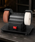 Badass Dual Wheel Bench Grinder With Sturdy Rubber Footed Base showing black benchtop machine with two abrasive wheels for garage work.
