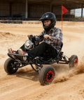 Person driving a Rugged 2000W Electric Go Kart For Adults And Kids Off Road Beast With 6 Inch Alloy Wheels on dirt track