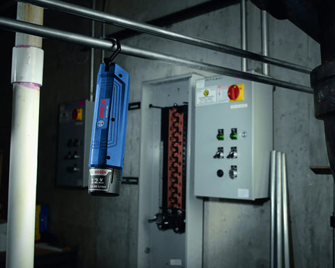 12V Max Lithium Ion Battery 2Ah Pack Two Battery Pack For Power Tools hanging in industrial setting near control panel