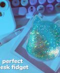 Blue Gelli Gel Squishy Boasting Slow Flow Glitter And Iconic Shape Memory For Ultimate Stress Relief And Seriously Dope Fidget Fun That Hits Different Every Time You Play on a desk with stationery.