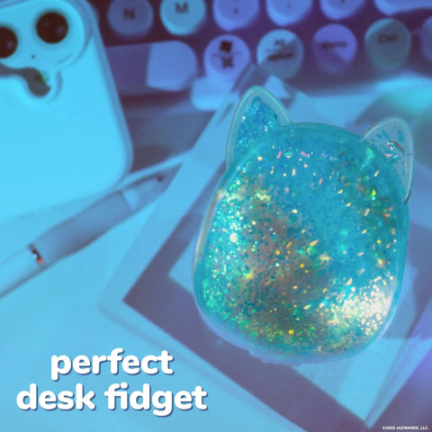 Blue Gelli Gel Squishy Boasting Slow Flow Glitter And Iconic Shape Memory For Ultimate Stress Relief And Seriously Dope Fidget Fun That Hits Different Every Time You Play on a desk with stationery.