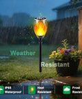 Solar Torch Lights With Flickering Flame Realistic Fire Effect For Outdoor Garden And Patio in rainy garden setting.