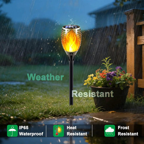 Solar Torch Lights With Flickering Flame Realistic Fire Effect For Outdoor Garden And Patio in rainy garden setting.