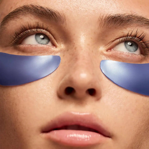 Close-up of a person wearing Jet Lag Under Eye Patches Hydrating Hydrogel Eye Masks With Caffeine And Peptides To Soothe Depuff.