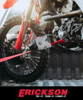 Red 1 Inch By 10 Foot Retractable Ratcheting Tie Down Straps attached securing motorcycle in truck bed.
