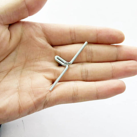 Close-up of a hand holding a metal clip, part of 50 Pack Lawn Chair Webbing Clips Made From Metal Spring Alloy For Lounge Chairs.
