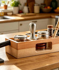 Premium 58 Mm Espresso Tamping Station Crafted From Warm Natural Wood with organized compartments and tools for coffee prep.