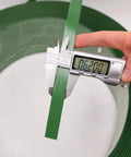 Measuring 5/8 inch width of Heavy Duty Green Polyester Strapping Roll For Solid Pallet Securing 5/8 Inch Wide By 4000 Feet Long.