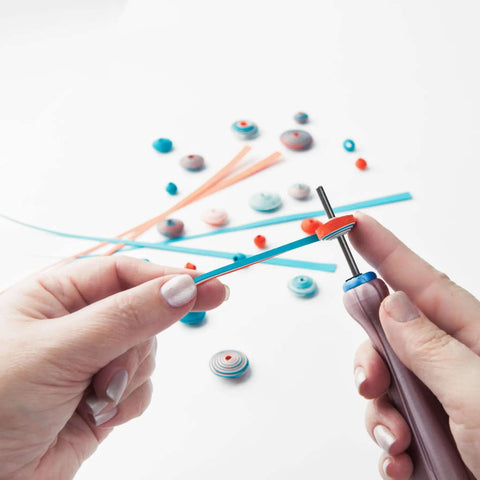 Two Piece Bead Roller Quilling Tool Kit with Slotted Winding Pins in use, showing pink pearl silk handle, bright stainless steel pin.