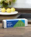 Convenient OMNIFilter Mail Home Water Test Kit on countertop, ready for analysis, ensuring top shelf drinking water quality daily.