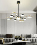 Modern Farmhouse Black And Gold LED Pendant Light 7 Light Sputnik Chandelier in a contemporary living room setting.