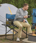 Person sitting on Oversized Tall Director Chair For Camping And Tailgating, Heavy Duty Folding Camp Chair with 500 Lb Capacity