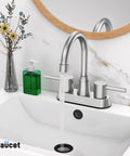 Brushed Nickel 4 Inch Centerset Bathroom Faucet With 2 Handles, Lead Free SUS304 Stainless Steel, Copper Pop Up Drain, 1.2 GPM Water Saving Aerator, No Splash, CEC Listed installed on a white bathroom sink with flowing water.