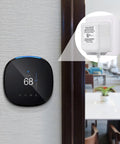 24 Volt C Wire Adapter For Smart Thermostats, UL Listed Power Connector, 16 And A Half Foot Cable next to thermostat on wall