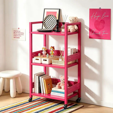 Rolling 3 Tier Metal Storage Organizer With Soft Pink Finish And Adjustable Foot Pads For Squishy Spaces Featuring Pop Off Guard Panels To Knock Kitchen Laundry And Garage Jumble Down Easy For Stress Free Home Upkeep Anywhere You Park It, holding toys and books.