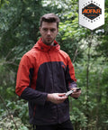 Man holding AF-374 Two Pack Magnesium Fire Starter With Waterproof Fire Steel Pouch in forest setting.