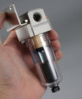 Close-up of Inline Pro Grade Air Filter And Moisture Trap With Automatic Drain For Shop And Garage, held in hand