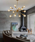 Modern Gold Sputnik Chandeliers Set Of 12 Brass Industrial Ceiling Lights For Dining Room Kitchen Living Room Farmhouse Style With Adjustable Height And Easy Install in living room setting with beige sectional sofa and fireplace.