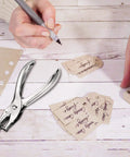 24 Pack 1/4 Inch Single Hole Punch Set Metal Paper Puncher With 5 Sheet Capacity silver finish shown next to handwritten tags on a desk