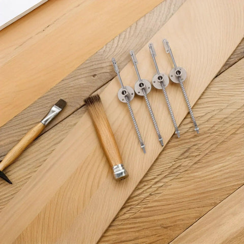 Four heavy duty cabinet door support rods with soft close lift hinges on wood surface, tools nearby for DIY kitchen and wardrobe installs.