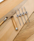 4 Pack Cabinet Door Support Rods With Soft Close next to wooden tools on textured background