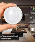 Person holding Color Changing LED Puck Lights With Remote Control, Dimmable Under Cabinet Kitchen Lighting, Battery Powered, 1 Pack