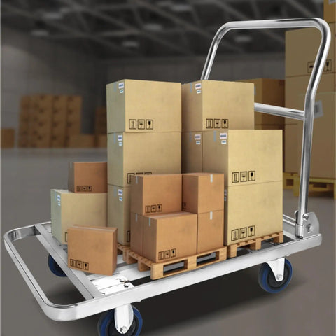 Heavy Duty Foldable Platform Push Cart With Smooth Rolling Rubber Wheels And Slick Stainless Steel Frame loaded with cardboard boxes in warehouse.
