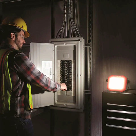 Electrician using 1100 Lumen LED Work Light With Tiltable Head Red Finish 4000K Cool White 2-In-1 Rotating Stand And Handle.