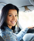 Happy driver smiling in car, showcasing Nifty Beige Sunglass Holder For Car Sun Visor That Snaps Right On To Keep Your Shades Tickets And Spare Cash Securely Stowed During Daily Commutes Or Weekend Road Trips Always.