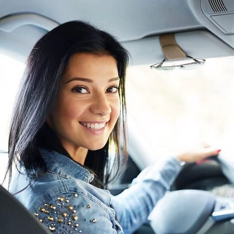 Happy driver smiling in car, showcasing Nifty Beige Sunglass Holder For Car Sun Visor That Snaps Right On To Keep Your Shades Tickets And Spare Cash Securely Stowed During Daily Commutes Or Weekend Road Trips Always.