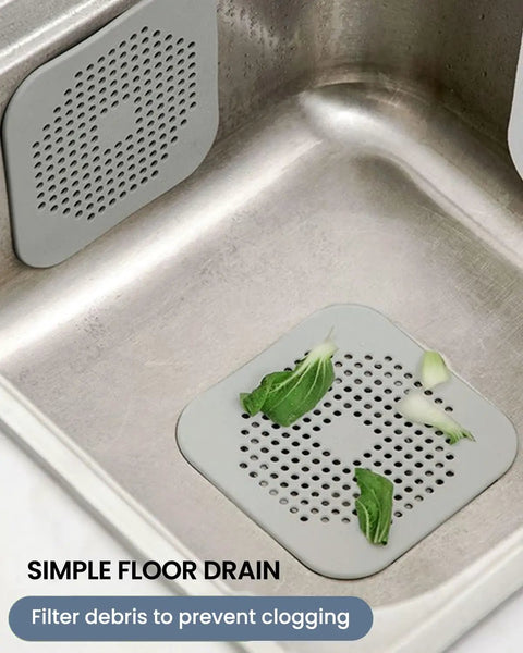 Heavy Duty Two Pack Square Hair Drain Catcher And Tub Filter With Grip Tight Suction Pads To Keep Your Shower Bathtub And Kitchen Sink Totally Clear Grey in a kitchen sink filtering debris.