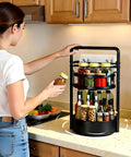 Woman using Rotating Spice Rack With Paper Towel Holder No Fuss Two Tier Lazy Susan For Spices Iron Kitchen Organizer Black Countertop Spin 360 Degree