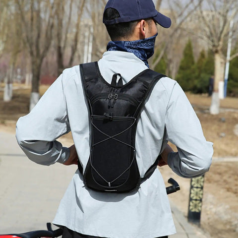 Person wearing Hydration Pack Backpack With Water Bottle Holder, Reflective Strips, Lightweight Nylon Reservoir outdoors