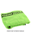Folded green fleece magnetic fender cover showing logo, ideal for mechanics. Magnetic Fender Cover For Mechanics, 42 By 24 Inch Soft Shield With Powerful Corner Magnets, Removable For Easy Cleaning, Keeps Car Fenders Protected During Repairs, Great Gift For Gearheads And Dads.