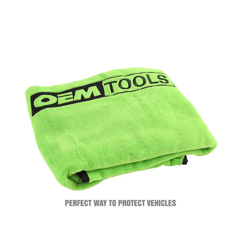 Folded green fleece magnetic fender cover showing logo, ideal for mechanics. Magnetic Fender Cover For Mechanics, 42 By 24 Inch Soft Shield With Powerful Corner Magnets, Removable For Easy Cleaning, Keeps Car Fenders Protected During Repairs, Great Gift For Gearheads And Dads.