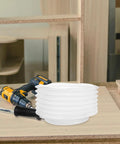 Heavy Duty Hole Saw Dust Bowl Catcher on workshop table, designed to clamp tight to bits and sweep chips away fast.