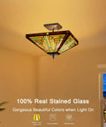 Tiffany Style Stained Glass Ceiling Lamp 2 Light 14 Inch Wide Amber Brown Semi Flush Mount glowing warmly in a room.