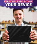 Man holding a tablet displaying text 'Keep dust and dirt off your device' in kitchen setting.